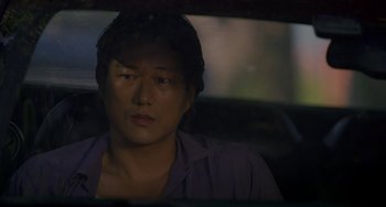 Movie still from “Bullet to the Head” (2012), directed by Walter Hill – A man sitting in a car looking out the window; Close Up shot, Over the shoulder angle