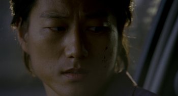 Movie still from “Bullet to the Head” (2012), directed by Walter Hill – A person's face with blood on it; Close Up shot, Over the shoulder angle