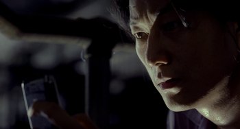 Movie still from “Bullet to the Head” (2012), directed by Walter Hill – A person looking at a cell phone; Extreme Close Up shot, Low angle