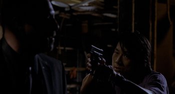 Movie still from “Bullet to the Head” (2012), directed by Walter Hill – A man and a woman holding guns in a dark room; Close Up shot, Over the shoulder angle