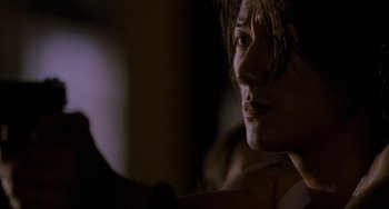 Movie still from “Bullet to the Head” (2012), directed by Walter Hill – A person's face in the dark; Close Up shot, Over the shoulder angle