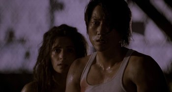 Movie still from “Bullet to the Head” (2012), directed by Walter Hill – A man and a woman standing next to each other; Close Up shot, Low angle