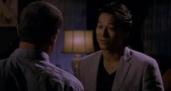 Movie still from “Bullet to the Head” (2012), directed by Walter Hill – A man in a gray jacket talking to another man in a black shirt; Close Up shot, Over the shoulder angle