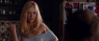 Movie still from “Burlesque” (2010), directed by Steve Antin – A woman with long blonde hair poses for the camera; Close Up shot, Over the shoulder angle