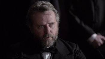 An older man with a beard and a bow tie