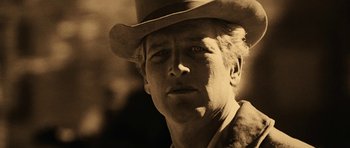 Movie still from “Butch Cassidy and the Sundance Kid” (1969), directed by George Roy Hill – A person wearing a cowboy hat; Close Up shot, Low angle
