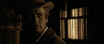 Movie still from “Butch Cassidy and the Sundance Kid” (1969), directed by George Roy Hill – A black and white photo of a man wearing a hat; Close Up shot, Over the shoulder angle