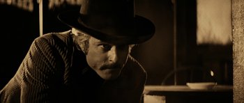 Movie still from “Butch Cassidy and the Sundance Kid” (1969), directed by George Roy Hill – A man with a hat and a mustache; Close Up shot, Over the shoulder angle