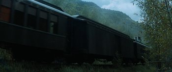 Movie still from “Butch Cassidy and the Sundance Kid” (1969), directed by George Roy Hill – A train traveling down train tracks next to a forest; Extreme Wide shot, Low angle