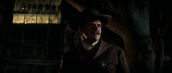 Movie still from “Butch Cassidy and the Sundance Kid” (1969), directed by George Roy Hill – A man with a mustache wearing a suit and a hat; Close Up shot, Low angle