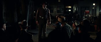 Movie still from “Butch Cassidy and the Sundance Kid” (1969), directed by George Roy Hill – A man in a suit and hat standing in front of a man in a cowboy hat; Wide shot, Over the shoulder angle