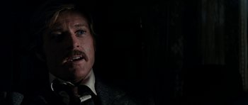 Movie still from “Butch Cassidy and the Sundance Kid” (1969), directed by George Roy Hill – A person wearing a suit and tie; Close Up shot, Over the shoulder angle