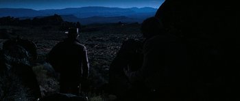 Movie still from “Butch Cassidy and the Sundance Kid” (1969), directed by George Roy Hill – A group of people standing on top of a hill at night; Wide shot, Over the shoulder angle
