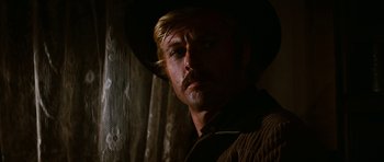 Movie still from “Butch Cassidy and the Sundance Kid” (1969), directed by George Roy Hill – A person wearing a cowboy hat; Close Up shot, Over the shoulder angle