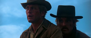 Movie still from “Butch Cassidy and the Sundance Kid” (1969), directed by George Roy Hill – Two men wearing hats and one of them is wearing a brown jacket; Close Up shot, Low angle