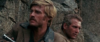 Movie still from “Butch Cassidy and the Sundance Kid” (1969), directed by George Roy Hill – A man with long blonde hair and a man with blonde hair; Close Up shot, Over the shoulder angle