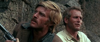 Movie still from “Butch Cassidy and the Sundance Kid” (1969), directed by George Roy Hill – A man with long blonde hair is looking up; Close Up shot, Low angle