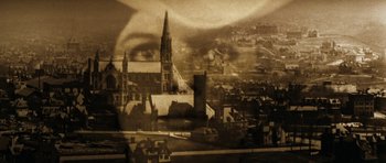 Movie still from “Butch Cassidy and the Sundance Kid” (1969), directed by George Roy Hill – An old photo of a church with a large eye in the background; Extreme Close Up shot, High angle