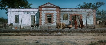 Movie still from “Butch Cassidy and the Sundance Kid” (1969), directed by George Roy Hill – An old brick building on the side of a train track; Extreme Wide shot, Low angle