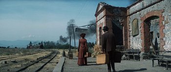 Movie still from “Butch Cassidy and the Sundance Kid” (1969), directed by George Roy Hill – A woman and a man are standing on the side of the road; Wide shot, Low angle