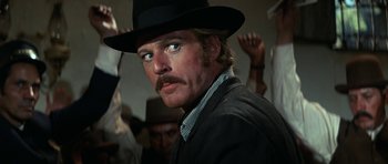 Movie still from “Butch Cassidy and the Sundance Kid” (1969), directed by George Roy Hill – A person wearing a hat and a suit; Close Up shot, Low angle