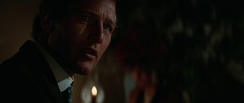 Movie still from “Butch Cassidy and the Sundance Kid” (1969), directed by George Roy Hill – A man's face with a candle in the background; Close Up shot, Over the shoulder angle