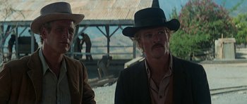Movie still from “Butch Cassidy and the Sundance Kid” (1969), directed by George Roy Hill – A man in a cowboy hat standing next to another man in a cowboy hat; Close Up shot, Low angle
