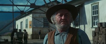 Movie still from “Butch Cassidy and the Sundance Kid” (1969), directed by George Roy Hill – An old man with a beard wearing a cowboy hat; Medium shot, Low angle