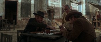 Movie still from “Butch Cassidy and the Sundance Kid” (1969), directed by George Roy Hill – A group of people sitting around a table; Medium shot, Over the shoulder angle