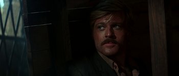 Movie still from “Butch Cassidy and the Sundance Kid” (1969), directed by George Roy Hill – A man in a suit and a mustache; Close Up shot, Over the shoulder angle