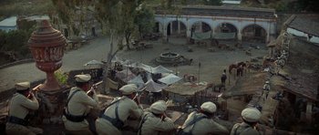 Movie still from “Butch Cassidy and the Sundance Kid” (1969), directed by George Roy Hill – A group of men sitting next to each other on top of a hill; Extreme Wide shot, High angle