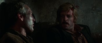 Movie still from “Butch Cassidy and the Sundance Kid” (1969), directed by George Roy Hill – A man with blood on his face and a man with blood on his face; Close Up shot, Over the shoulder angle