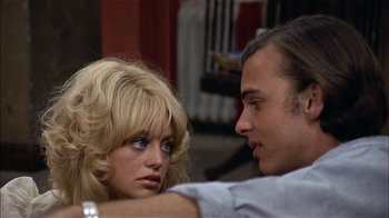 Movie still from “Butterflies Are Free” (1972), directed by Milton Katselas – A man and a woman sitting next to each other; Close Up shot, Low angle