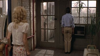 Movie still from “Butterflies Are Free” (1972), directed by Milton Katselas – A man and a woman looking out of an open door; Wide shot, Over the shoulder angle