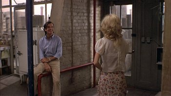 Movie still from “Butterflies Are Free” (1972), directed by Milton Katselas – A man and a woman are talking to each other; Medium shot, Over the shoulder angle