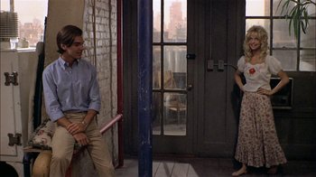 Movie still from “Butterflies Are Free” (1972), directed by Milton Katselas – A man and a woman standing in front of an open door; Wide shot, Over the shoulder angle