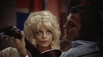 Movie still from “Butterflies Are Free” (1972), directed by Milton Katselas – A man and a woman are looking at each other; Close Up shot, Over the shoulder angle