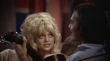 Movie still from “Butterflies Are Free” (1972), directed by Milton Katselas – A man and a woman talking to each other; Close Up shot, High angle