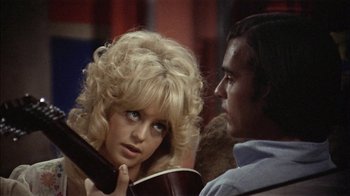 Movie still from “Butterflies Are Free” (1972), directed by Milton Katselas – A man and a woman looking at one another; Close Up shot, Over the shoulder angle