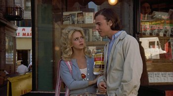 Movie still from “Butterflies Are Free” (1972), directed by Milton Katselas – A man and a woman standing next to each other; Medium shot, Over the shoulder angle