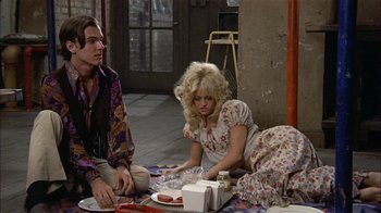 Movie still from “Butterflies Are Free” (1972), directed by Milton Katselas – A woman sitting on the ground next to a man; Medium shot, High angle