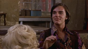 Movie still from “Butterflies Are Free” (1972), directed by Milton Katselas – A man sitting in front of a blond woman; Close Up shot, Over the shoulder angle