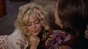 Movie still from “Butterflies Are Free” (1972), directed by Milton Katselas – A woman is getting her hair combed by another woman; Close Up shot, Over the shoulder angle