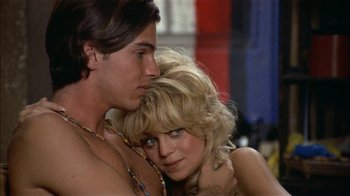 Movie still from “Butterflies Are Free” (1972), directed by Milton Katselas – A man and a woman embracing each other in front of a mirror; Close Up shot, Low angle