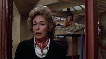 Movie still from “Butterflies Are Free” (1972), directed by Milton Katselas – An older woman in a black jacket and a woman in a red and white striped neck tie; Close Up shot, Over the shoulder angle