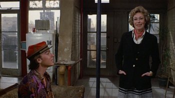 Movie still from “Butterflies Are Free” (1972), directed by Milton Katselas – A man and a woman standing in front of a building; Medium shot, Over the shoulder angle