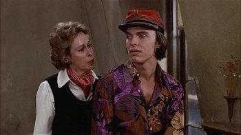 Movie still from “Butterflies Are Free” (1972), directed by Milton Katselas – An older woman standing next to a young man; Medium shot, Over the shoulder angle