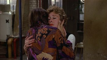 Movie still from “Butterflies Are Free” (1972), directed by Milton Katselas – A woman hugging another woman while they both look sad; Close Up shot, Over the shoulder angle