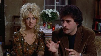 Movie still from “Butterflies Are Free” (1972), directed by Milton Katselas – A man and a woman sitting in front of a dining table; Close Up shot, Over the shoulder angle