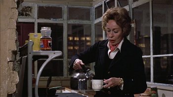 Movie still from “Butterflies Are Free” (1972), directed by Milton Katselas – An older woman pouring tea into a cup; Medium shot, High angle